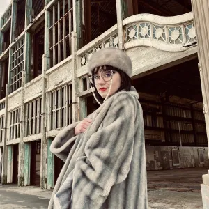 Vivian DeRosa in a fur coat outside an older building with an ornate railing