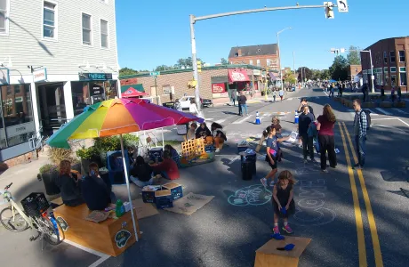 A ParKit set up in the street, a scene filled with people and games