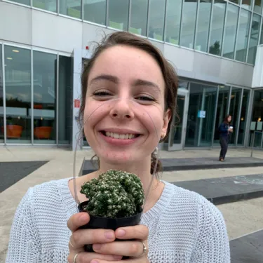 Katharine Anderson holding a succulent and smiling