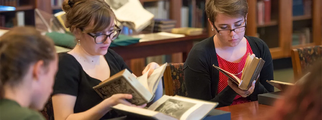 Students looking at books in the Mortimer Rare Book Room