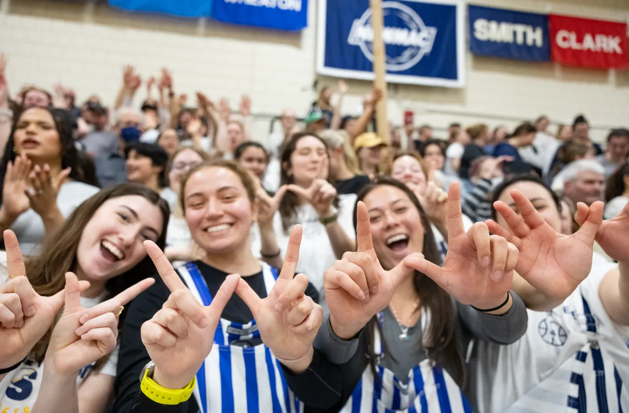 Fans cheering during a basketball game.