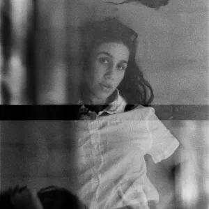 Black and white photo: Garret Bradley looking at the camera through a gauzy film