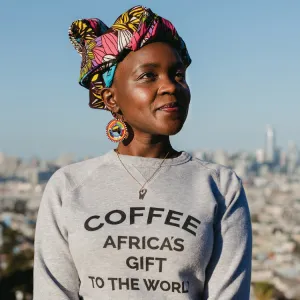 Margaret Nyamumbo wearing a sweatshirt with the slogan "Coffee: Africa's Gift to the World"