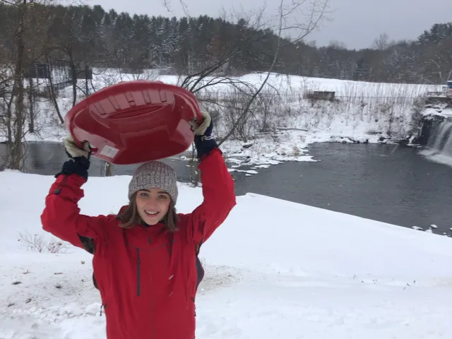 Harriet Wright in the snow with a sled