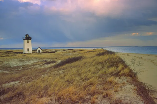 A small lighthouse on the shore of Cape Cod