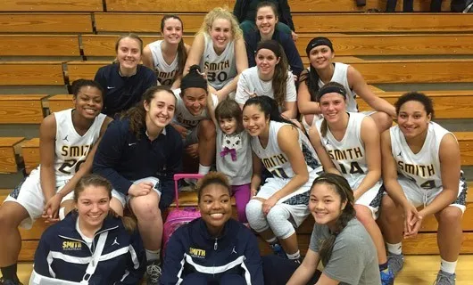 Members of the Pioneers with Madison Conley, 7, of Northampton, who has been paired with the basketball team through a nonprofit program.