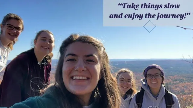 Five smiling white people on top of a mountain. Overlay text, "Take things slow and enjoy the journey!"