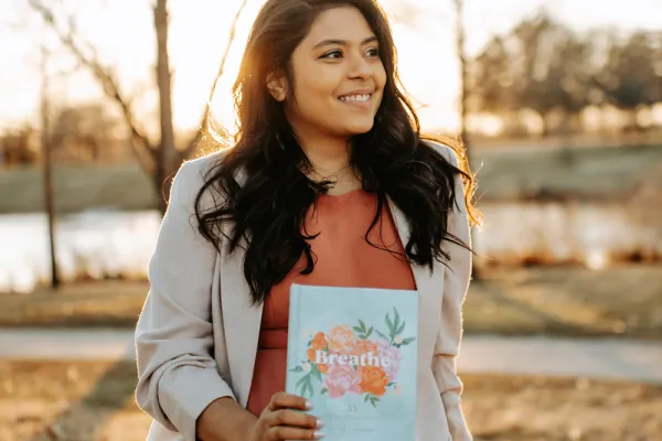 Shanila Sattar holding her book Breathe