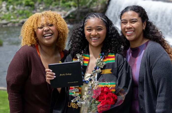 A student smiles with their family during Commencement