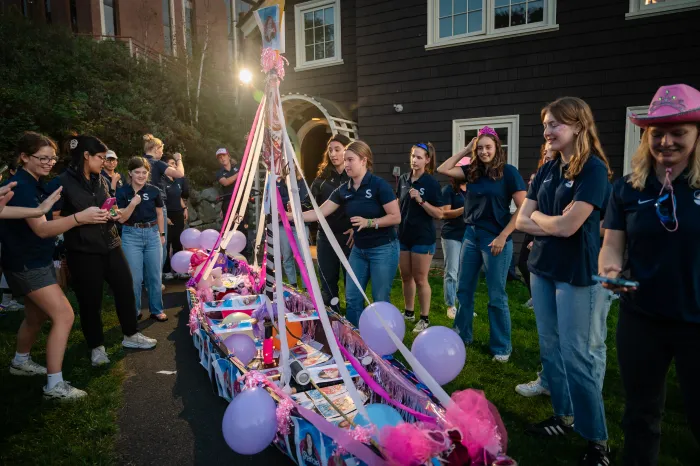 Students gather around a decorated canoe during Float Night 2023