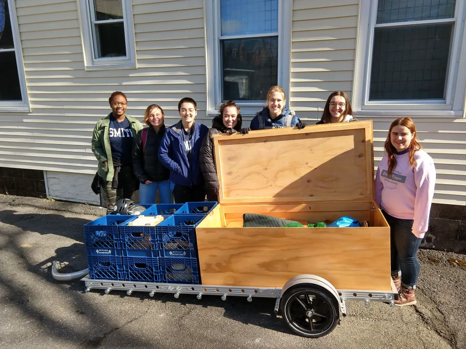 Students pose with their portable ParKit packed up on a trailer