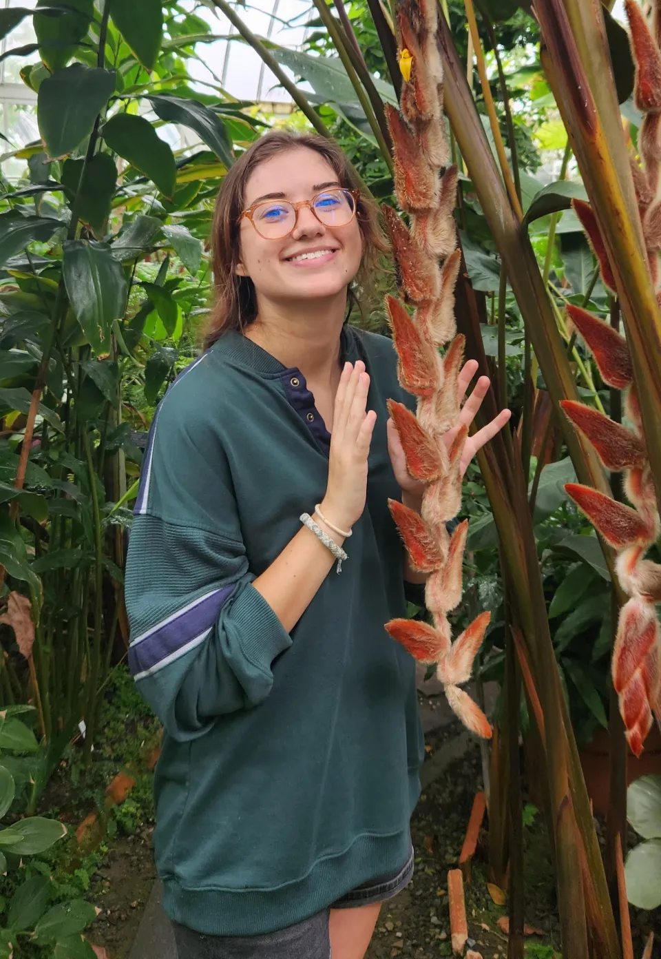 Ulla Collins Axelson ’24 in the botanic garden with a plant