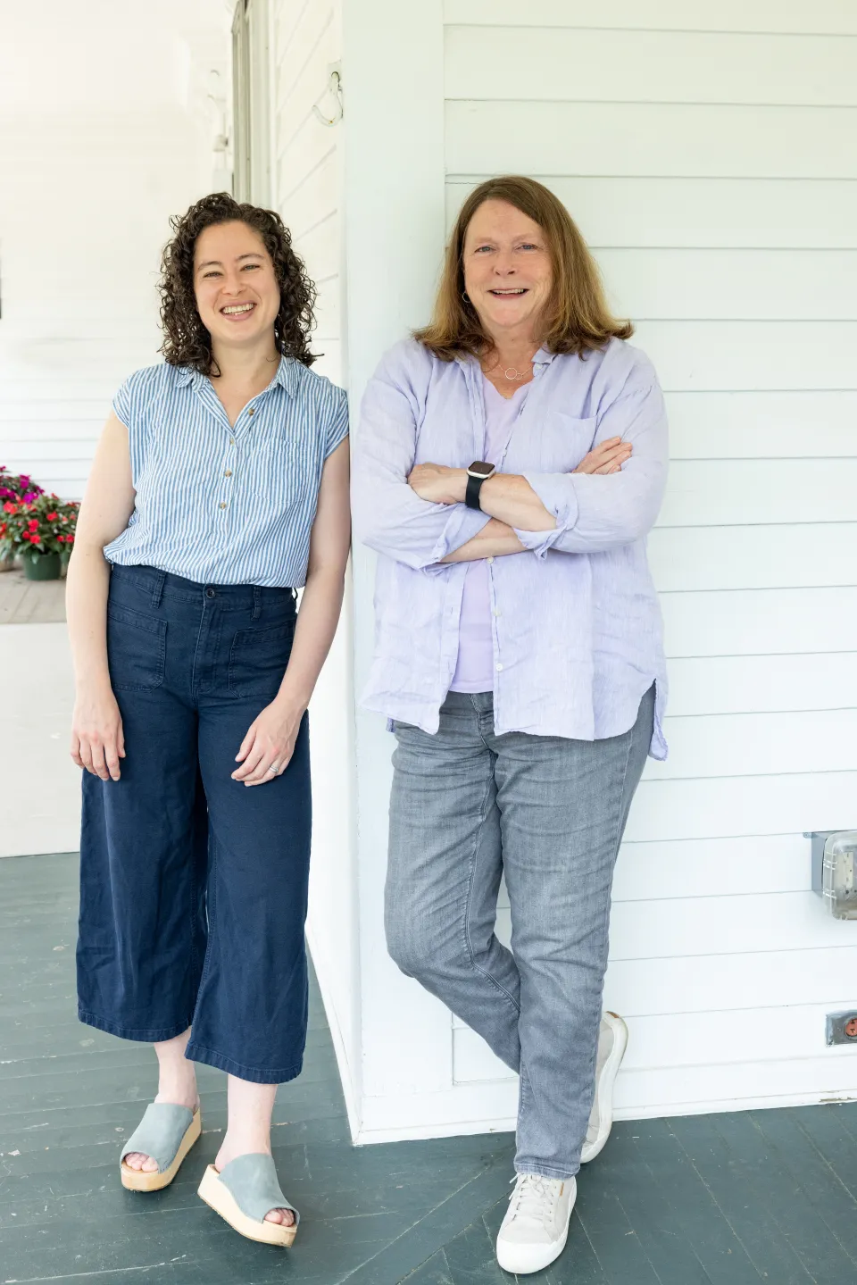 Suzanne Gottschang, the Kahn’s director and  professor of anthropology and East Asian studies, and Kathleen Pierce, assistant professor of art, pose together on a white porch