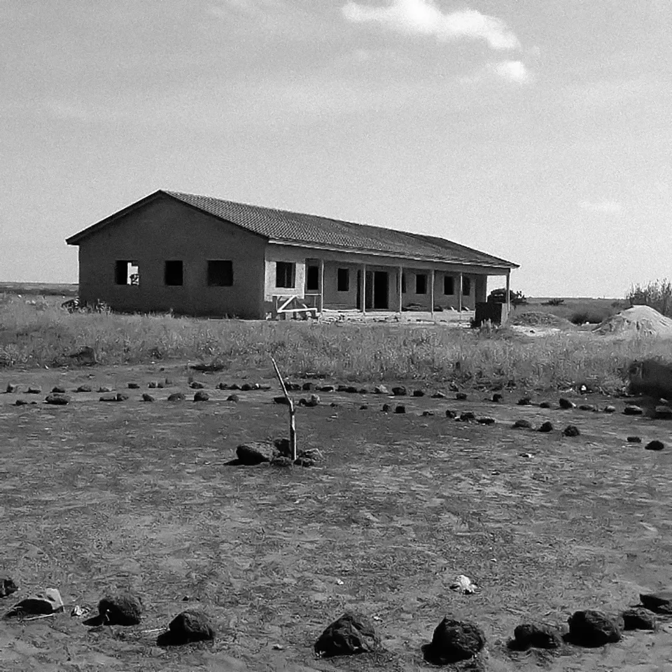 A black-and-white photograph of the school under construction.