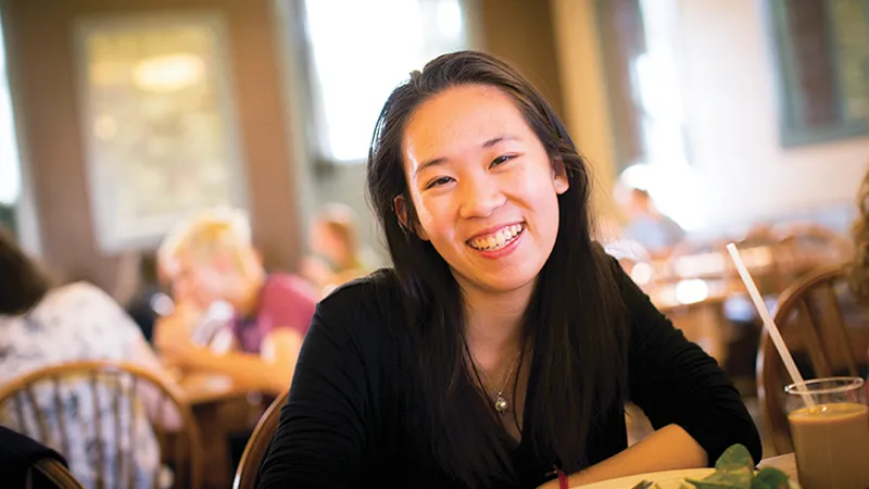 Agnes Hu in a college dining room