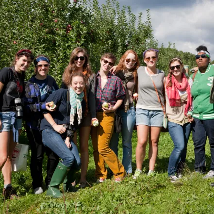 A group of students picking apples on Mountain Day.